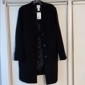 Long button down blazer. Brand new. Never worn.